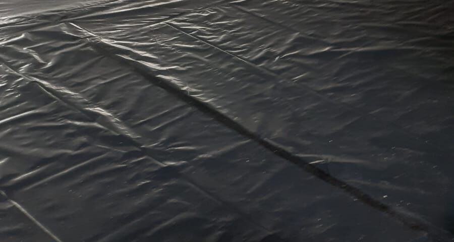 Close-up of the slip membrane and perimeter edge strip installed on the 600m² floor in Cambridgeshire.