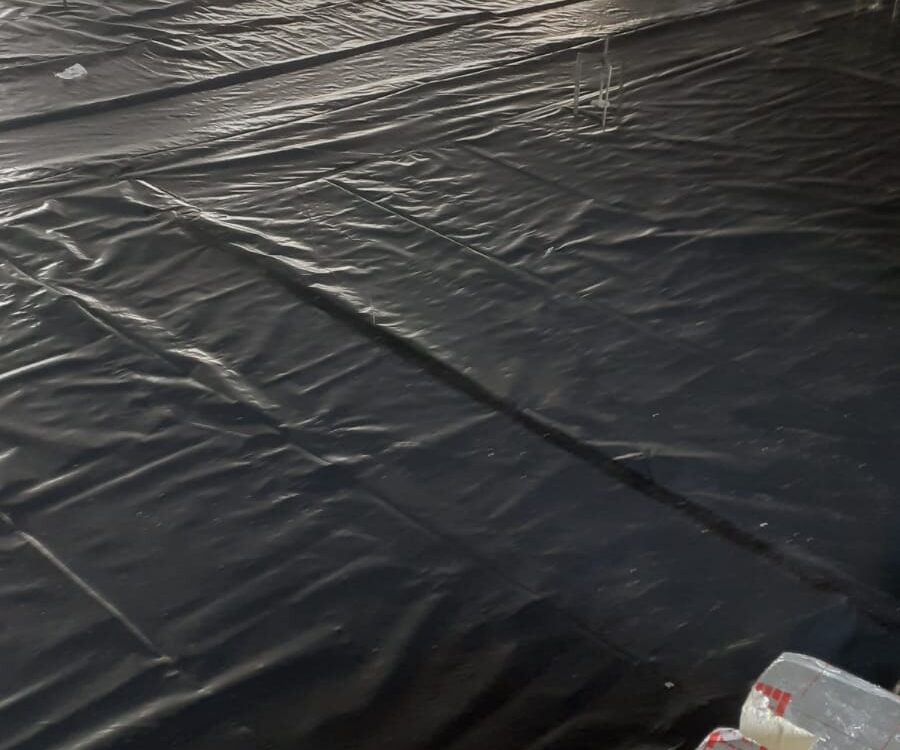 Close-up of the slip membrane and perimeter edge strip installed on the 600m² floor in Cambridgeshire.